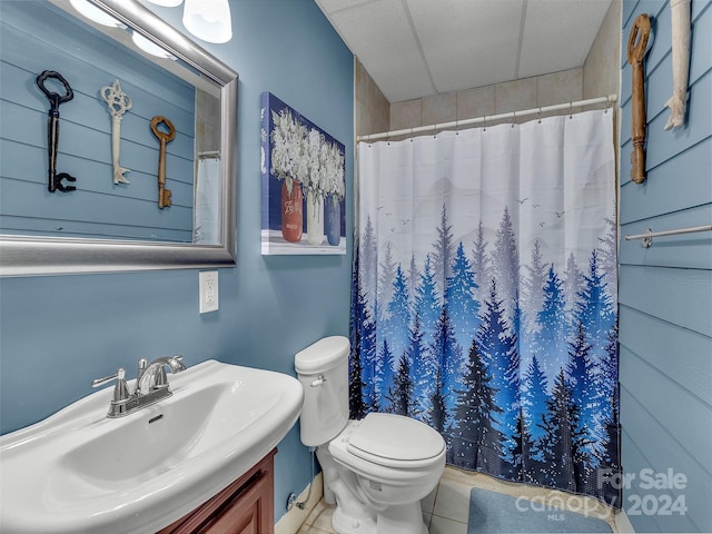 bathroom featuring tile patterned floors, sink, walk in shower, and toilet