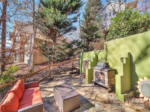 view of patio / terrace with an outdoor living space with a fireplace