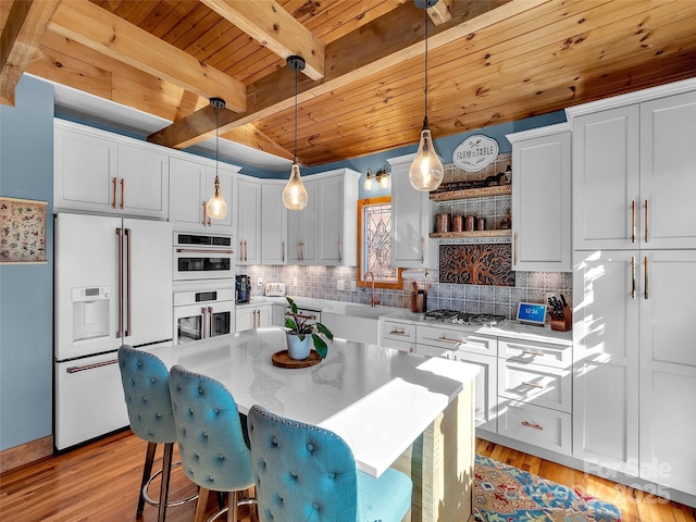 kitchen with white appliances, wood ceiling, white cabinetry, hanging light fixtures, and a center island