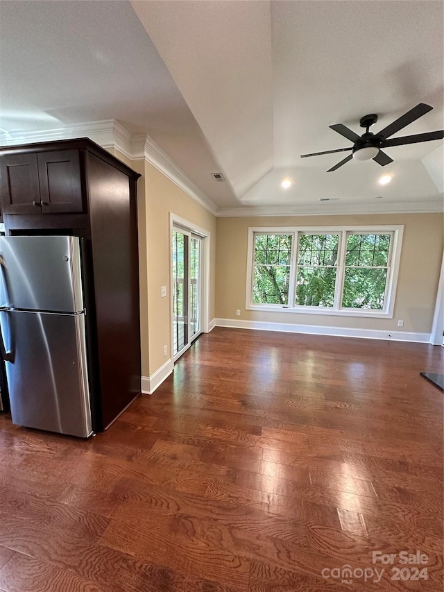 kitchen with dark hardwood / wood-style flooring, ornamental molding, dark brown cabinetry, stainless steel refrigerator, and lofted ceiling