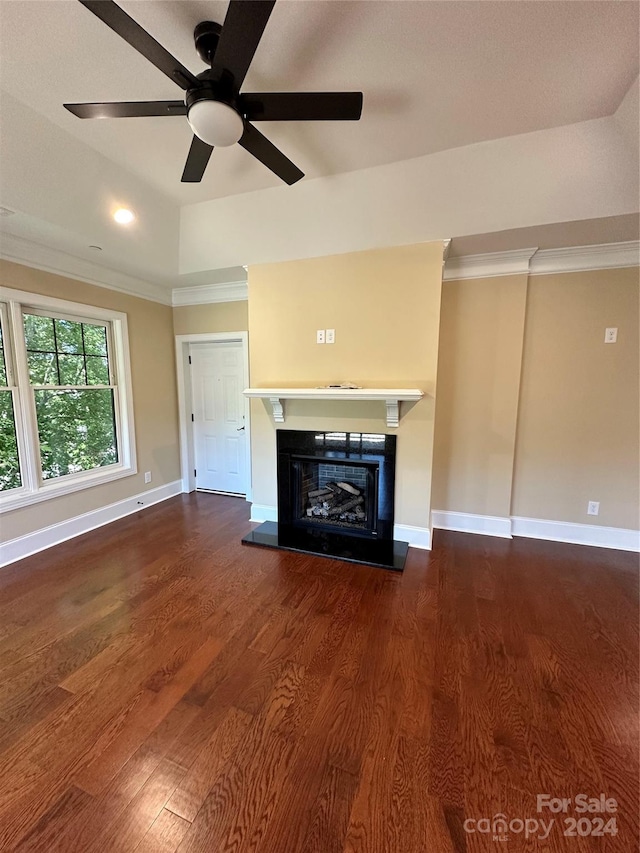 unfurnished living room with ornamental molding, lofted ceiling, ceiling fan, and dark wood-type flooring