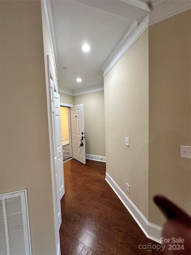 hallway featuring ornamental molding and dark wood-type flooring