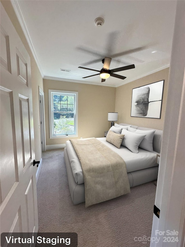 carpeted bedroom with ceiling fan and ornamental molding