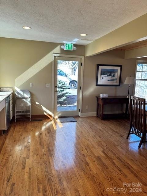 entryway with hardwood / wood-style floors and a textured ceiling