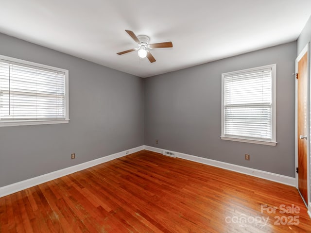 empty room featuring hardwood / wood-style flooring and ceiling fan