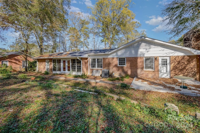 back of house featuring french doors, a yard, and central AC