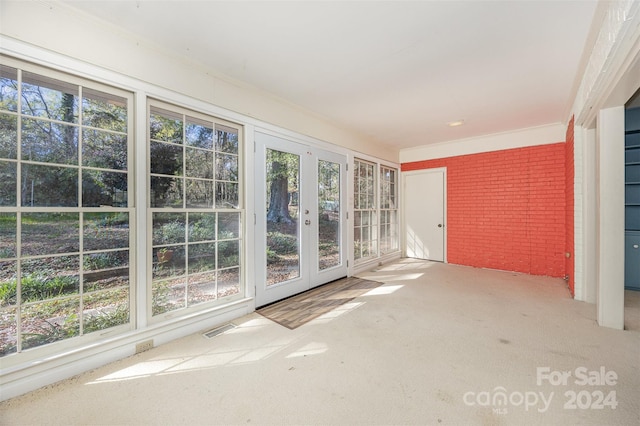 unfurnished sunroom with french doors