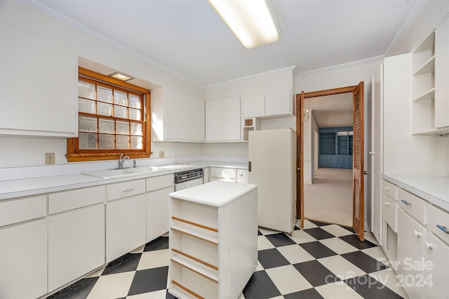 kitchen featuring white fridge, white cabinetry, sink, and ornamental molding