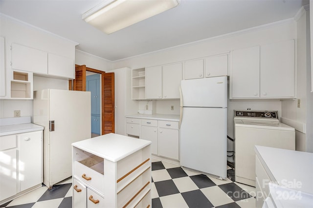 kitchen with washer / clothes dryer, white cabinets, and white refrigerator