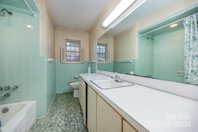 full bathroom featuring vanity, tile patterned floors, crown molding, toilet, and tile walls