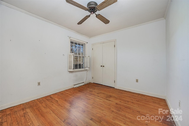 unfurnished room featuring ceiling fan, light hardwood / wood-style floors, crown molding, and a baseboard radiator