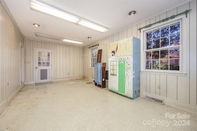 spare room featuring wooden walls