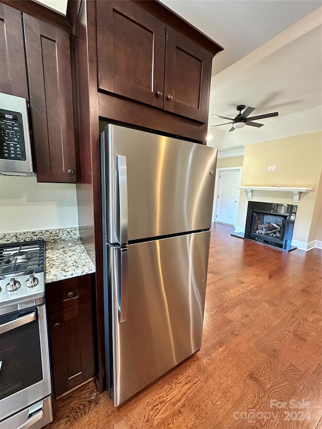 155 Gateway Dr Unit 101, Boone, NC 28607 - kitchen featuring appliances with stainless steel finishes, a ceiling fan, dark brown cabinets, and a fireplace