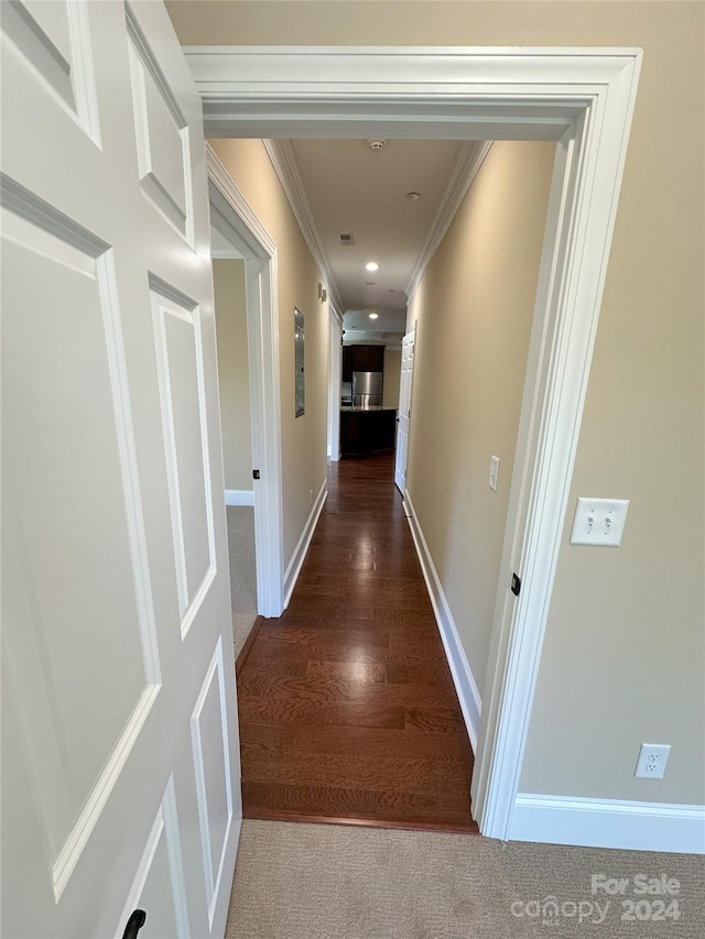 corridor featuring hardwood / wood-style flooring and crown molding