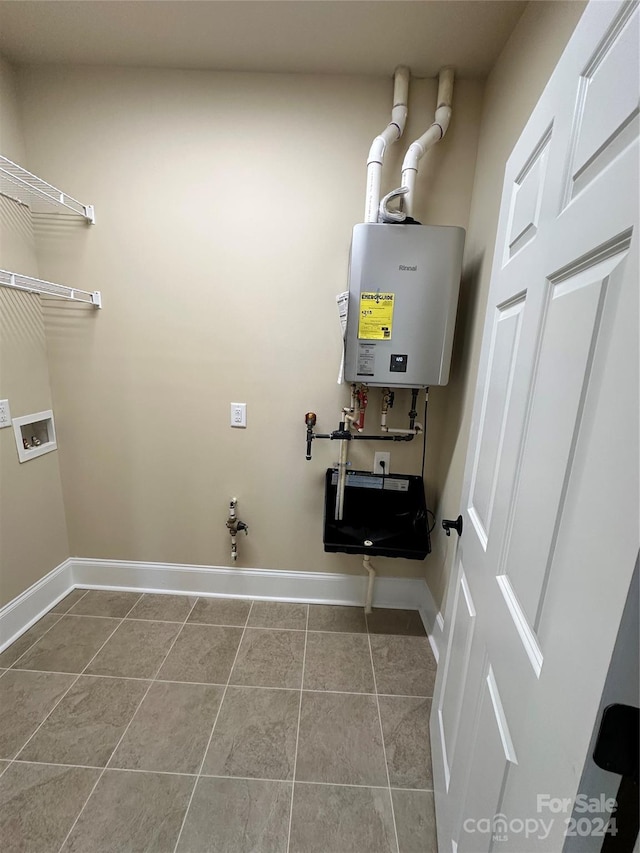 155 Gateway Dr Unit 101, Boone, NC 28607 - washroom with tankless water heater, washer hookup, and tile patterned flooring