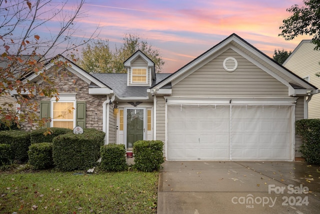 105 Ranlo Ave, Gastonia, NC 28054 - traditional home with driveway, an attached garage, stone siding, and roof with shingles