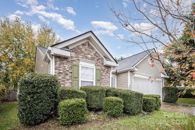 105 Ranlo Ave, Gastonia, NC 28054 - view of front facade with stone siding, an attached garage, concrete driveway, and roof with shingles
