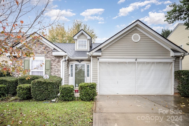 105 Ranlo Ave, Gastonia, NC 28054 - view of front of home featuring driveway, an attached garage, stone siding, and roof with shingles