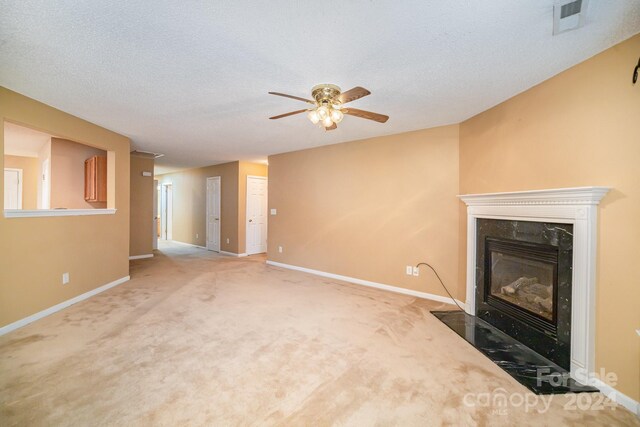 105 Ranlo Ave, Gastonia, NC 28054 - unfurnished living room with baseboards, ceiling fan, a high end fireplace, carpet flooring, and a textured ceiling