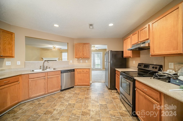 kitchen featuring a textured ceiling, stainless steel appliances, ceiling fan, and sink