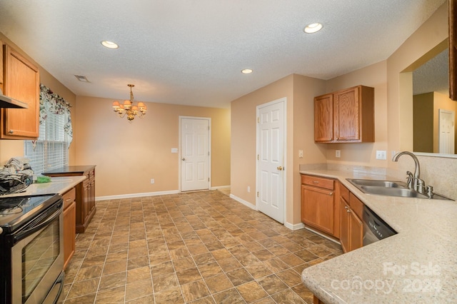 kitchen featuring sink, stainless steel appliances, a notable chandelier, pendant lighting, and a textured ceiling