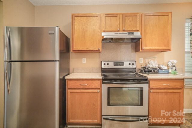 105 Ranlo Ave, Gastonia, NC 28054 - kitchen with stainless steel appliances, under cabinet range hood, and light countertops