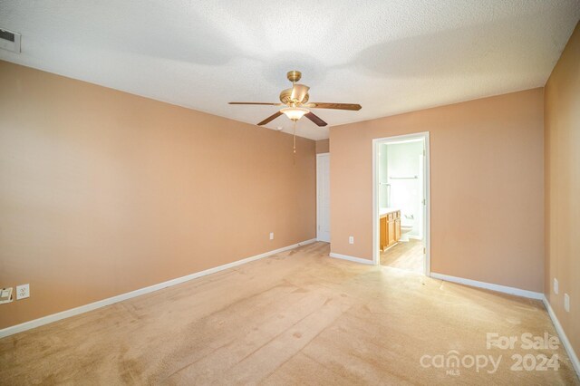 105 Ranlo Ave, Gastonia, NC 28054 - spare room featuring ceiling fan, light colored carpet, baseboards, and a textured ceiling