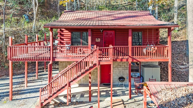 view of front of house with a patio area and a wooden deck