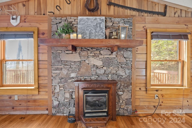 interior details featuring hardwood / wood-style flooring and wooden walls