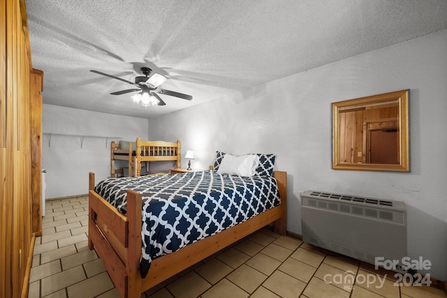 bedroom with radiator heating unit, a textured ceiling, and ceiling fan