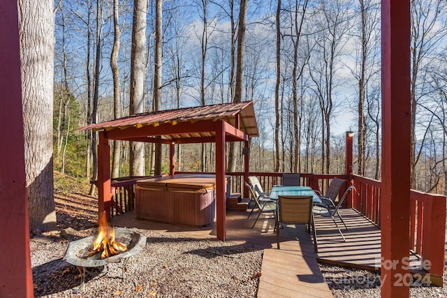 wooden deck featuring a fire pit and a hot tub