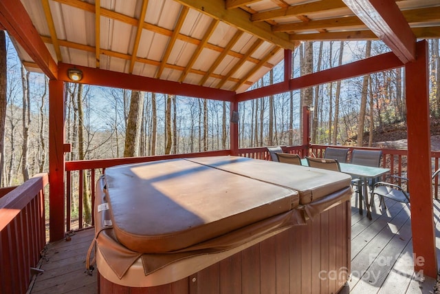 wooden deck with a hot tub