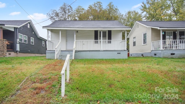 bungalow-style home with covered porch and a front yard