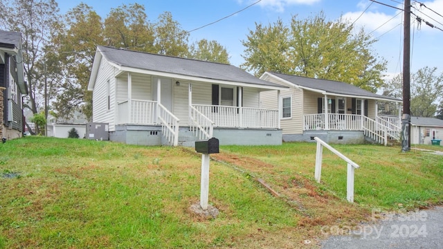 single story home with covered porch and a front yard