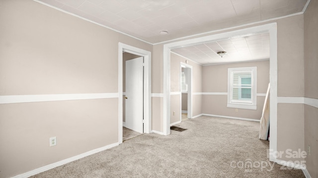 408 E Washington Ave, Bessemer City, NC 28016 - empty room featuring light carpet, baseboards, visible vents, and ornamental molding