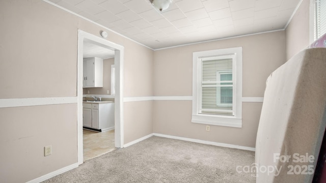 408 E Washington Ave, Bessemer City, NC 28016 - unfurnished room featuring light carpet, baseboards, ornamental molding, and a sink
