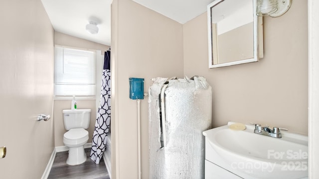 408 E Washington Ave, Bessemer City, NC 28016 - bathroom featuring toilet, baseboards, wood finished floors, and vanity
