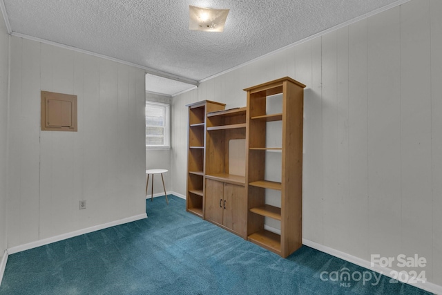2664 Charles Teague Pl, Lenoir, NC 28645 - spare room with ornamental molding, dark carpet, a textured ceiling, and wood walls