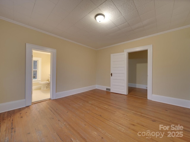 unfurnished room with light hardwood / wood-style flooring and ornamental molding