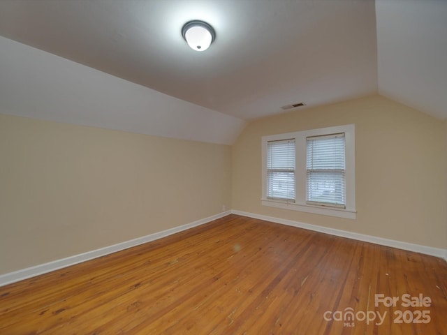 additional living space with lofted ceiling and light hardwood / wood-style floors