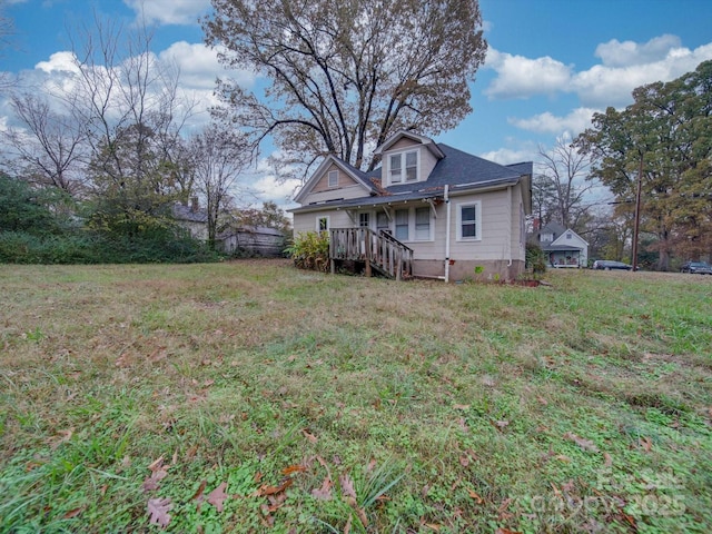 back of house with a wooden deck and a lawn