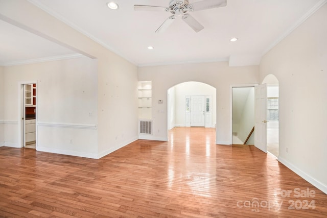 empty room featuring crown molding, light hardwood / wood-style flooring, and ceiling fan