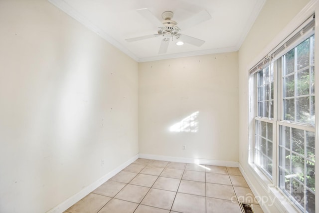 tiled spare room with ceiling fan, a healthy amount of sunlight, and ornamental molding