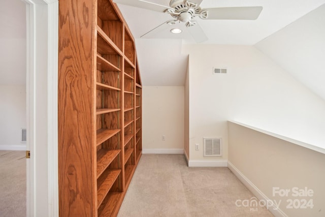 interior space with ceiling fan, light colored carpet, and vaulted ceiling