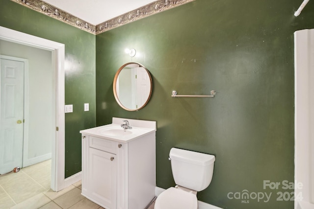 bathroom with tile patterned flooring, vanity, and toilet