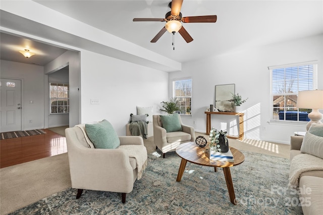 carpeted living room featuring a wealth of natural light and ceiling fan