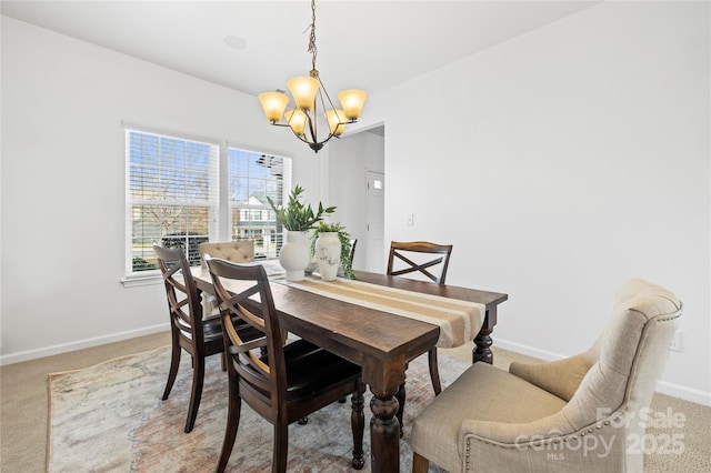 dining area with carpet flooring and a chandelier