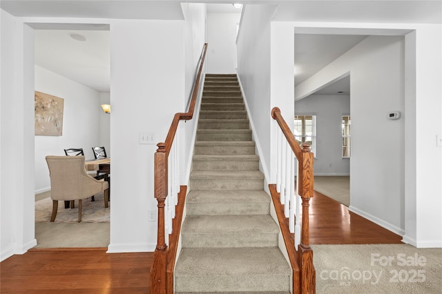 stairs with hardwood / wood-style floors