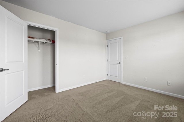 unfurnished bedroom with a closet and carpet