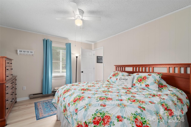 bedroom featuring crown molding, light hardwood / wood-style flooring, ceiling fan, a textured ceiling, and a baseboard radiator